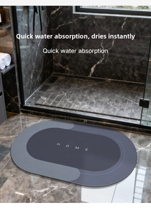 Detailed close-up of quick-absorbing diatom mud bathroom mat with Home text design