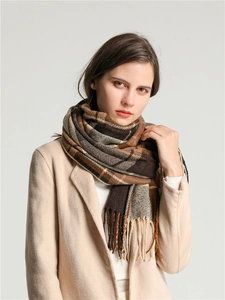 Close-up of retro plaid scarf in brown and beige tones showing soft fringe texture
