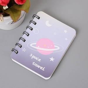 Detail of A7 spiral notebook featuring a purple galaxy cover and black dual-wire binding