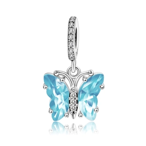 Macro detail of silver butterfly pendant with blue gemstone wings and clear diamonds