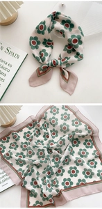 Detail of cotton linen square scarf with green floral pattern and fine stitched edges