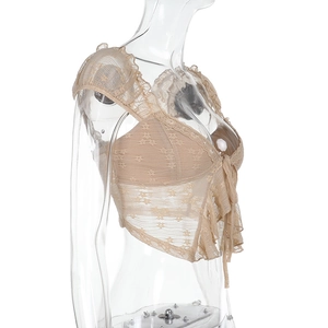 Side view detail of beige lace crop top with ruffled edges and delicate tie-up design