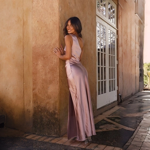 Detail of elegant satin one-shoulder slit dress in dusty rose with a silky glossy finish