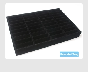 Detail view of black velvet bangle display tray with 4 rows of storage slots for jewelry