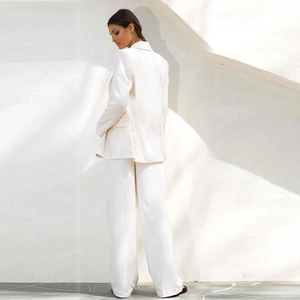Chic two-piece white suit for women featuring long sleeve blazer and wide-leg trousers
