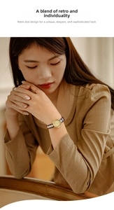 Detail of vintage gold quartz watch with blue white striped strap worn by a female model