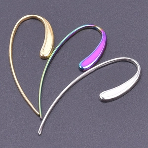 Macro shot of minimalist water-drop earring hooks in gold, silver, and gradient finishes