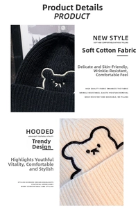 Detailed view of the soft cotton knit texture and cute bear embroidery on the beanie