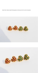 Macro detail of red and green heart stud earrings with gold beaded edges and zircons