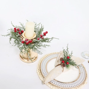 Christmas candle ring with snowy red berries and pine branches for holiday table decor