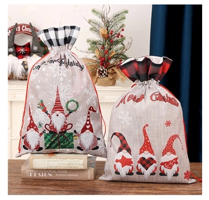 Detail view of festive linen Christmas gift bags with gnome prints and plaid drawstring