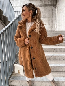 Close-up of caramel teddy fleece coat with lapel collar and black button detailing