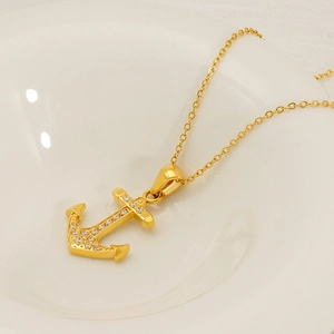 18K gold plated anchor necklace with micro-set zircons on white ceramic display plate