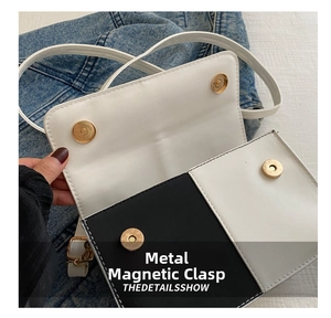 Dettaglio macro di borsa a tracolla bicolore in pelle con chiusura a fibbia magnetica oro