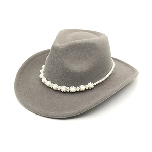 Detail of grey felt cowboy hat with elegant white pearl flower headband on white background