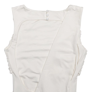 Close-up of white backless dress featuring side ruching and elegant neck button closure