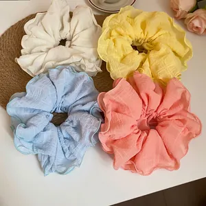 Oversized pastel chiffon scrunchies with floral ruffled edges and subtle plaid texture