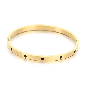 Golden stainless steel round bangle featuring minimalist black stone inlay in a high-polished finish