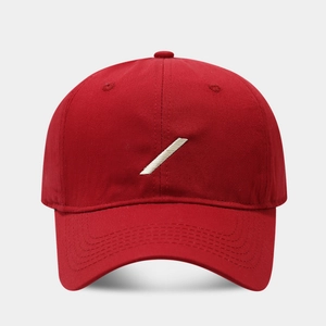Detailed close-up of red cotton baseball cap with white diagonal embroidered stripes