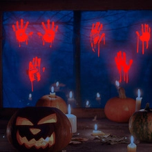 Detail of red bloody handprint stickers with dripping effect for Halloween window decor