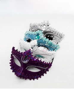 Close-up of elegant masquerade masks with rhinestones and lace in multiple colors