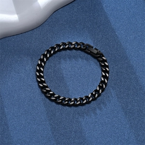 Close-up of black punk Cuban link bracelet on a textured background