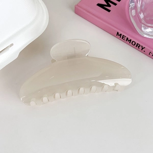 Close-up of a French style beige acrylic shark hair claw clip with smooth finish