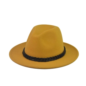 Detail of mustard yellow wool fedora hat with a bold black chain decorative band
