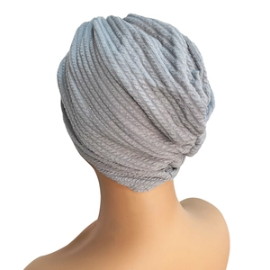 Detailed back view of light gray waffle knit turban hat with cross twist design and texture