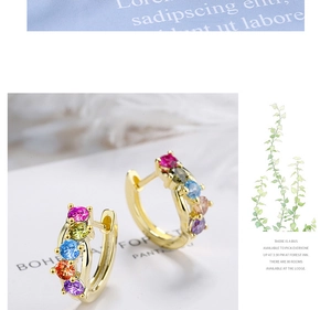 Detail of gold huggie hoop earrings with five vibrant multi-colored round gemstones