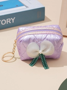 Purple quilted bow coin purse with pearl decor and golden keyring on a clean background