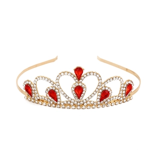 Detailed close-up of golden crown featuring red teardrop gems and white rhinestones