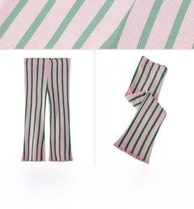 Detail of pink and green striped flare leggings showing ribbed knit fabric and wavy hem