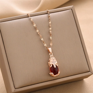 Rose gold titanium steel necklace with a Pi Xiu pendant and deep red gemstone