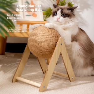Detail of wooden triangular cat scratcher toy with a sisal rope ball for pet play