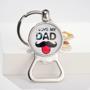 Detail of metal bottle opener keychain featuring I LOVE MY DAD print under a glass dome