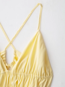 Gros plan d'une robe jaune à bretelles montrant les coutures et le tissu lisse