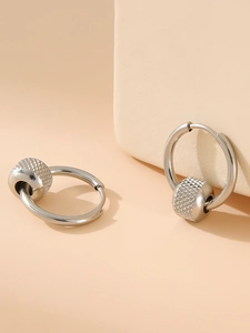 Detail of silver stainless steel hoop earrings with knurled textured beads