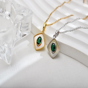 Luxurious gold and silver rhombus pendants with green emerald and mother of pearl