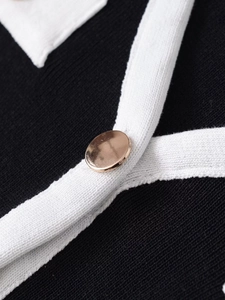Detail of soft ribbed knit cardigan featuring contrast white trim and rose gold button