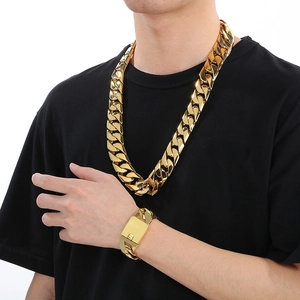 Fashionable 24mm gold polished Cuban chain necklace and bracelet set for men on model