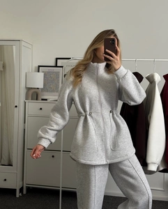 Women's grey zip-up sweatshirt and drawstring joggers set shown in a lifestyle mirror selfie