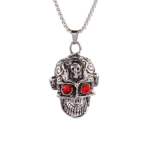 Gothic silver skull necklace with red gemstone eyes and intricate metal relief on white background