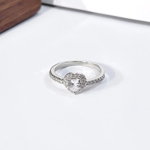 Detailed view of silver heart-shaped ring with pavé diamonds and side stone accents