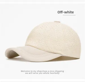 Close-up of off-white woven texture and fabric brim on a stylish baseball cap