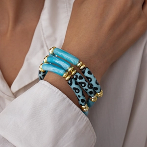 Detailed view of a 3-piece acrylic bangle set with leopard print and vibrant blue accents