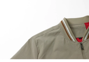 Detail of khaki work jacket collar with striped ribbing and red mesh lining
