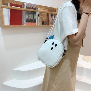 Détail du sac bandoulière fantôme blanc avec sangle en tissu et boucle noire