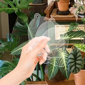 Three clear acrylic bell-shaped blanks with hanging holes for DIY Christmas ornaments
