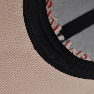 Close-up of internal cotton cap construction with red contrast stitching and sweatband